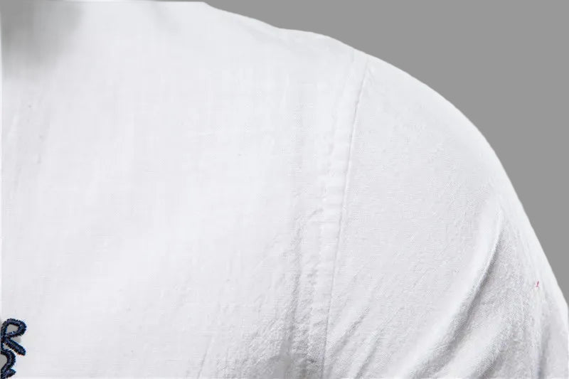 Close-up of a white shirt with a small logo on a white background