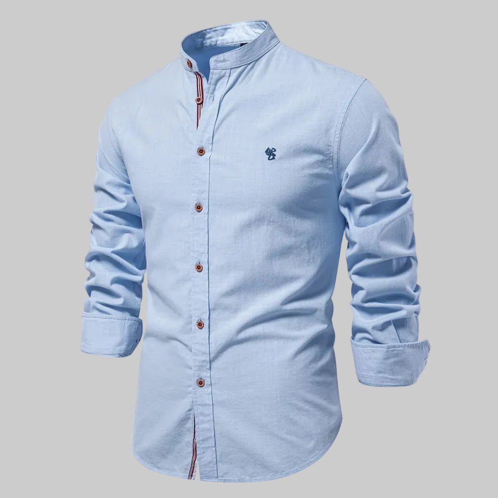 Light blue button-up shirt with a small logo on a white background