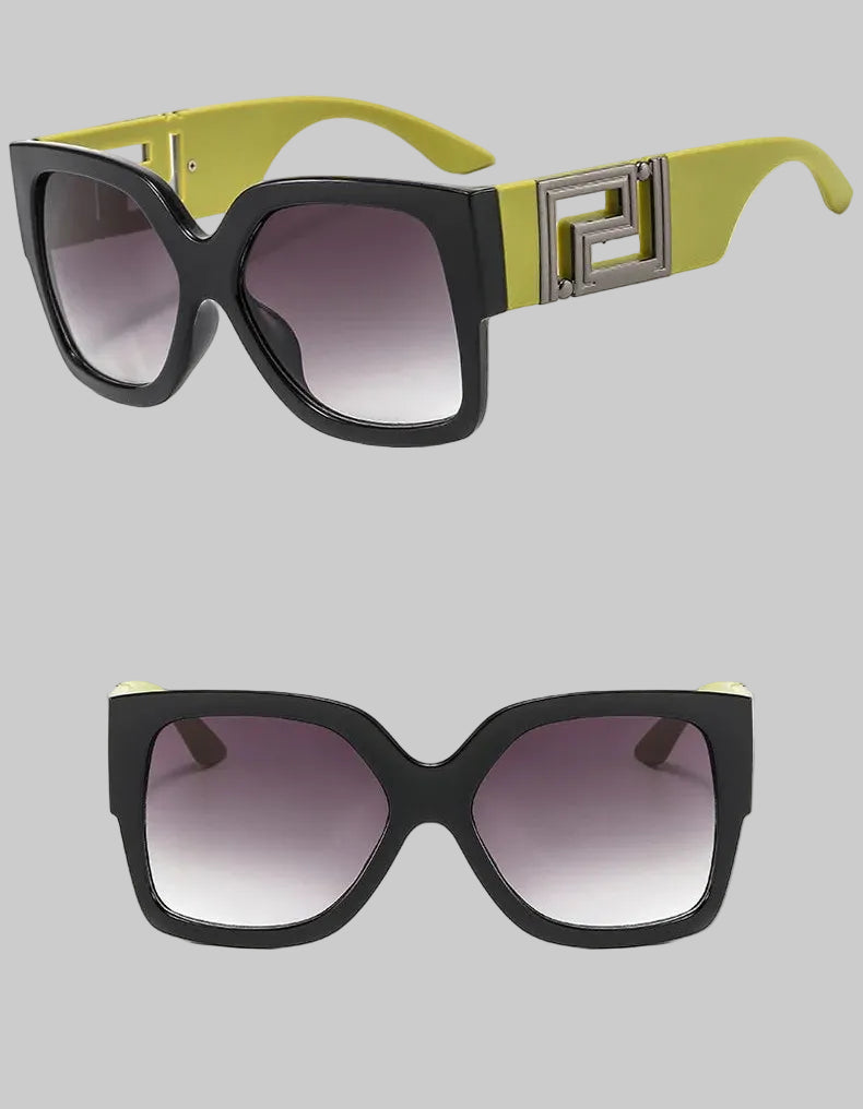 A pair of oversized square sunglasses shown from two angles on a white background. The frames are black with a bright yellow-green temple and a silver geometric accent.