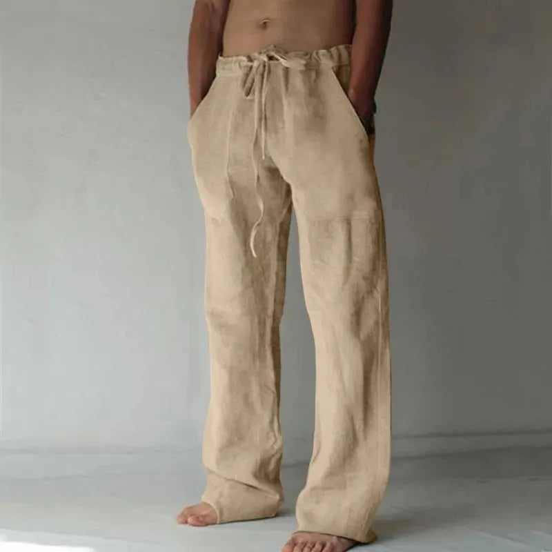 Beige linen pants worn by a person on a plain background